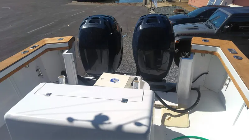 Slide: The Image of 1986 Blackfin 27 Cuddy boat with dual outboard motors, rear view. - 3