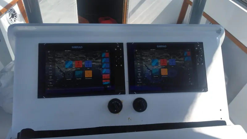Slide: The Image of Dual Simrad displays on 1986 Blackfin 27 Cuddy boat dashboard. - 4