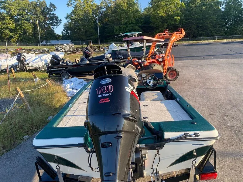 Slide: The Image of 2002 Bumble Bee 18 boat with Suzuki 140 outboard motor in a parking lot. - 10