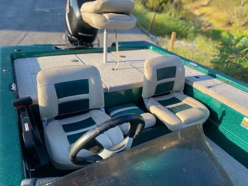 Slide: The Image of 2002 Bumble Bee 18 boat interior with dual seats and steering wheel. - 4