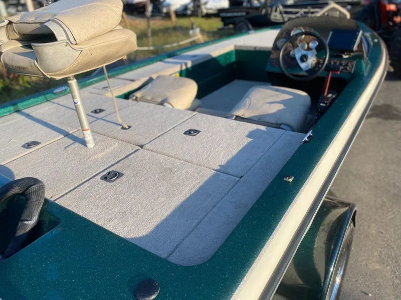 Slide: The Image of 2002 Bumble Bee 18 boat interior with steering wheel and cushioned seats. - 7