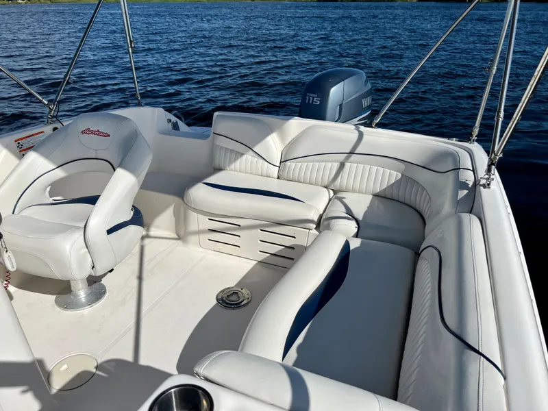 Slide: The Image of 2006 Hurricane 194 boat interior with white seating on a calm lake. - 20