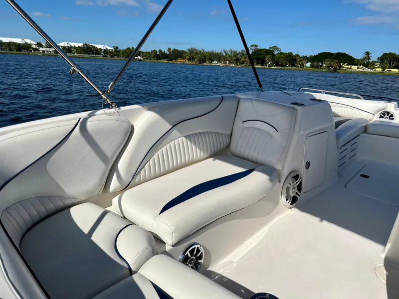 Slide: The Image of 2006 Hurricane 194 boat interior with white seating, on a sunny day by the water. - 24