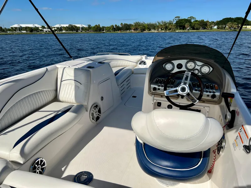 Slide: The Image of 2006 Hurricane 194 boat interior with steering wheel and seating on a sunny day. - 26