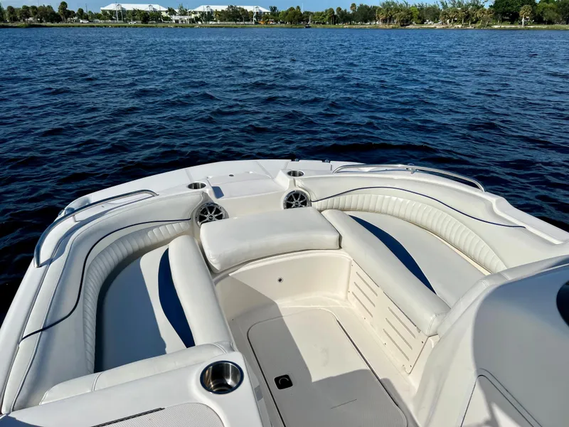 Slide: The Image of 2006 Hurricane 194 boat interior with white seating on a calm lake. - 27
