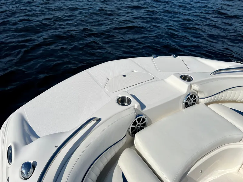 Slide: The Image of Hurricane 194 boat deck, 2006 model, with white seating and cup holders on calm water. - 28