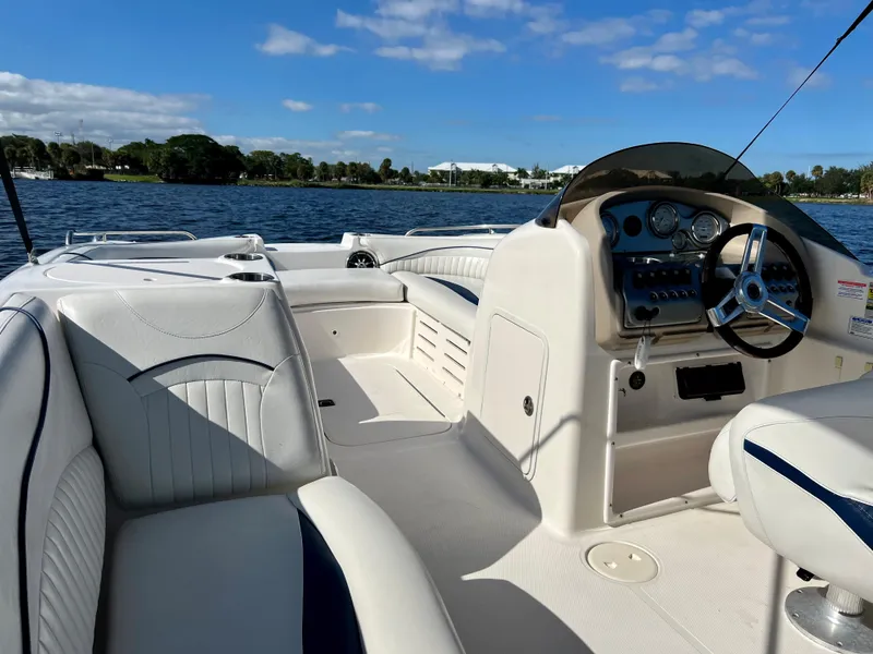 Slide: The Image of Interior of a 2006 Hurricane 194 boat with white seating and steering wheel. - 29