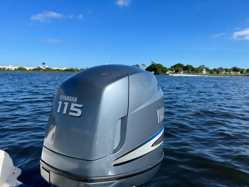 Slide: The Image of Yamaha 115 outboard motor on a 2006 Hurricane 194 boat, scenic water view. - 31