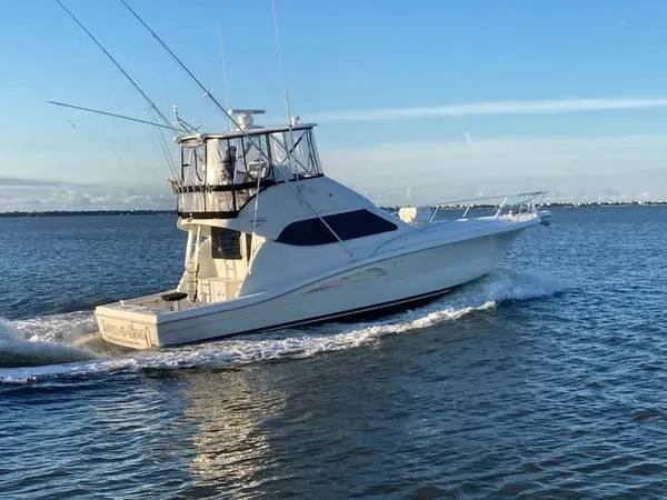 Slide: The Image of 2005 Rampage 45 Convertible Yacht cruising on calm waters. - 11