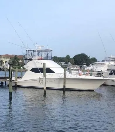 Slide: The Image of 2005 Rampage 45 Convertible yacht docked at harbor. - 12