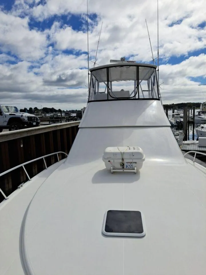 Slide: The Image of 2005 Rampage 45 Convertible boat docked under cloudy sky. - 18