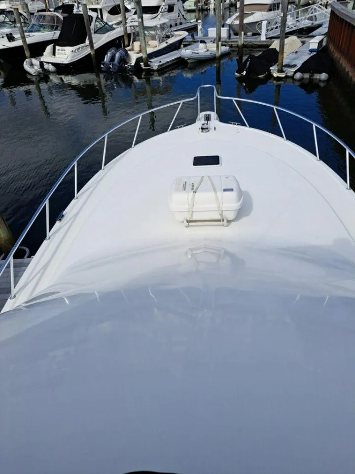 Slide: The Image of Deck view of 2005 Rampage 45 Convertible yacht in marina. - 22
