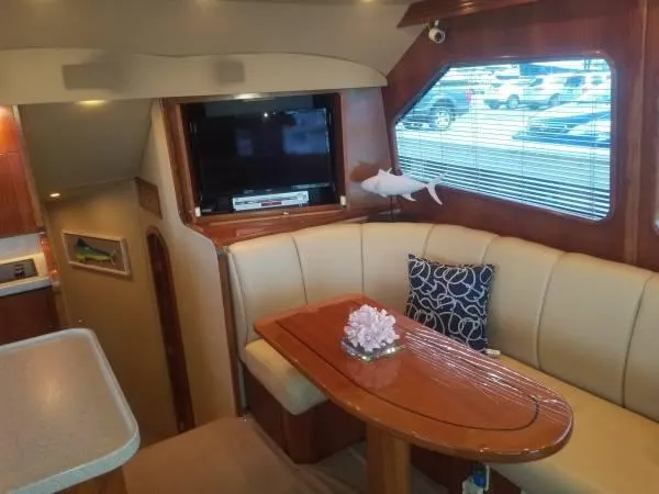 Slide: The Image of Interior of a 2005 Rampage 45 Convertible yacht with sofa and table. - 4