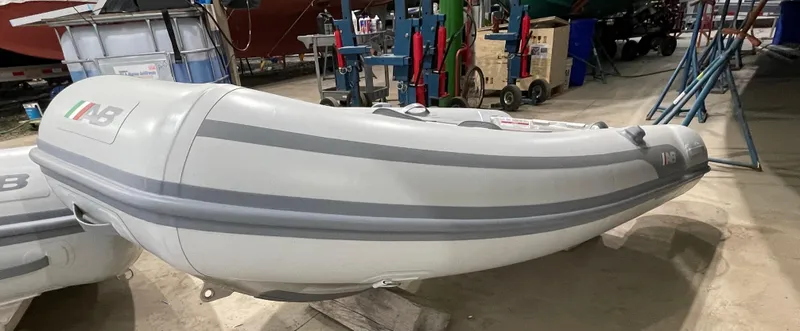 Slide: The Image of 2024 AB Inflatables Lammina 9 AL boat in a workshop setting. - 2
