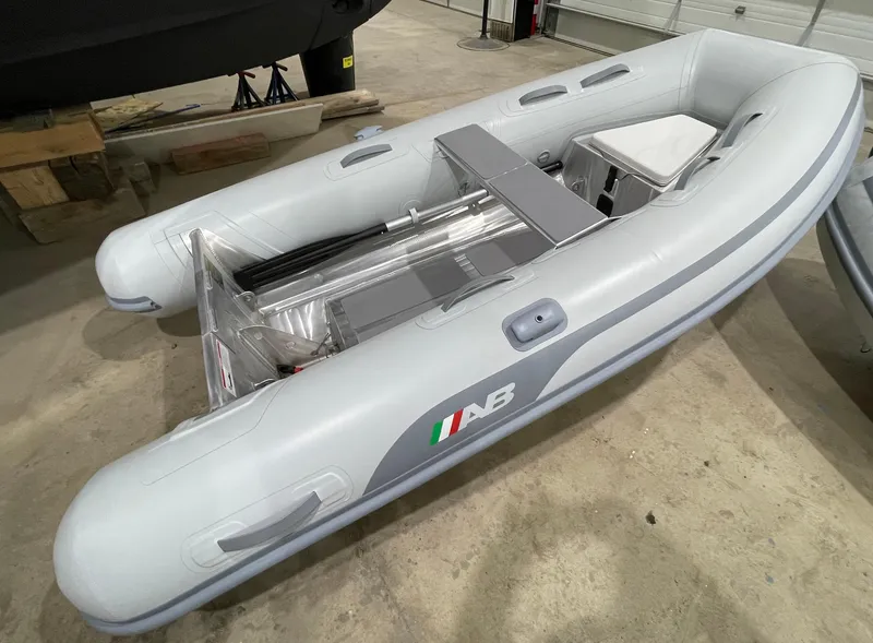 Slide: The Image of 2024 AB Inflatables Lammina 9 AL boat, gray, in a showroom setting. - 3