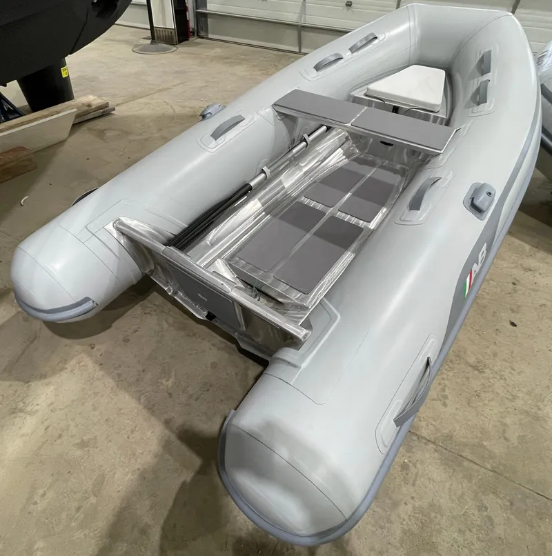 Slide: The Image of 2024 AB Inflatables Lammina 9 AL inflatable boat in a showroom setting. - 4