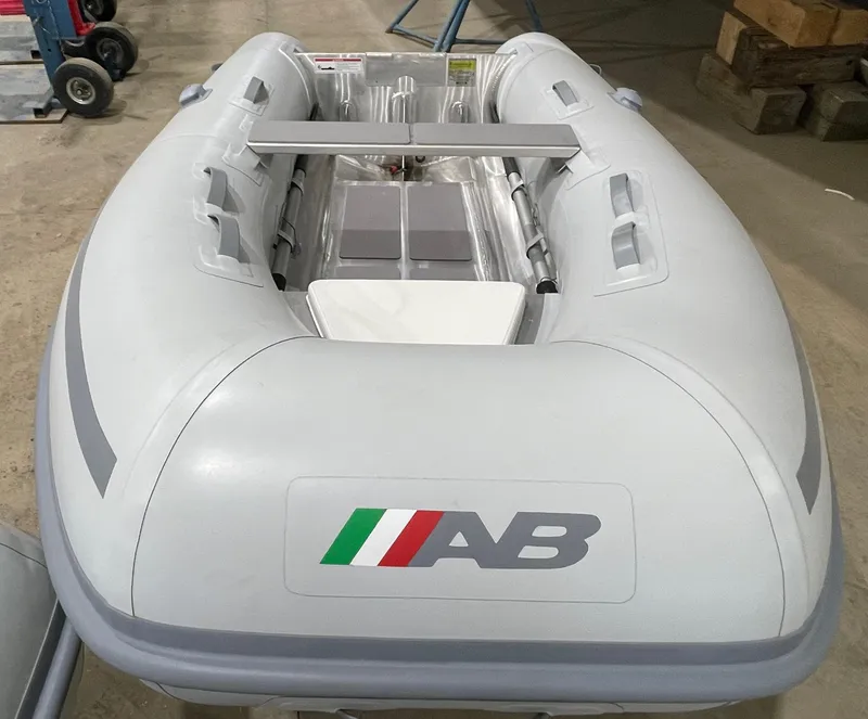 Slide: The Image of 2024 AB Inflatables Lammina 9 AL inflatable boat in a warehouse setting. - 5