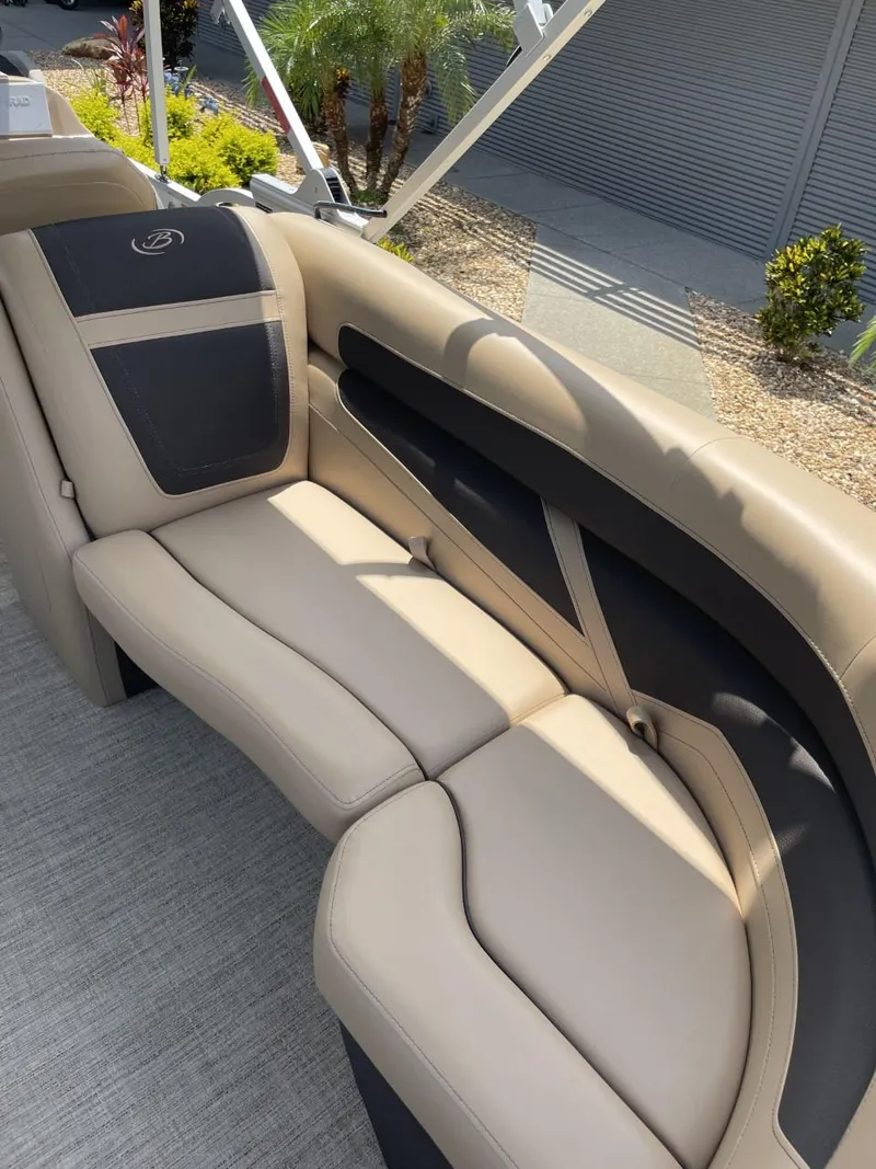 Slide: The Image of 2022 Barletta Cabrio 22QC boat interior with beige and black seating. - 12