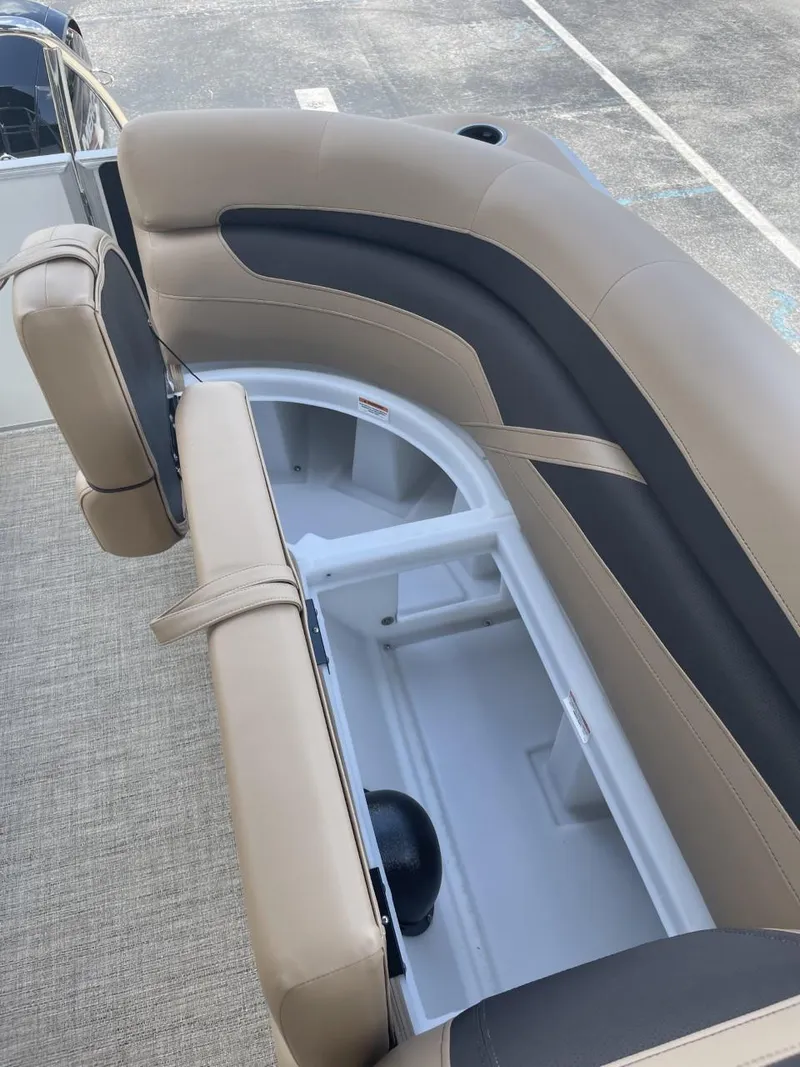 Slide: The Image of 2022 Barletta Cabrio 22QC boat seat storage compartment, beige and black upholstery. - 13