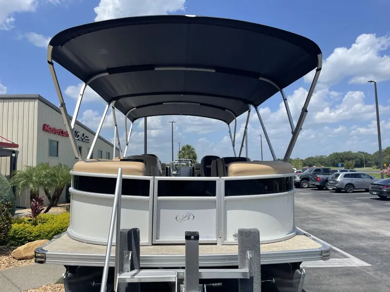 Slide: The Image of 2022 Barletta Cabrio 22QC pontoon boat with canopy, parked outdoors. - 6