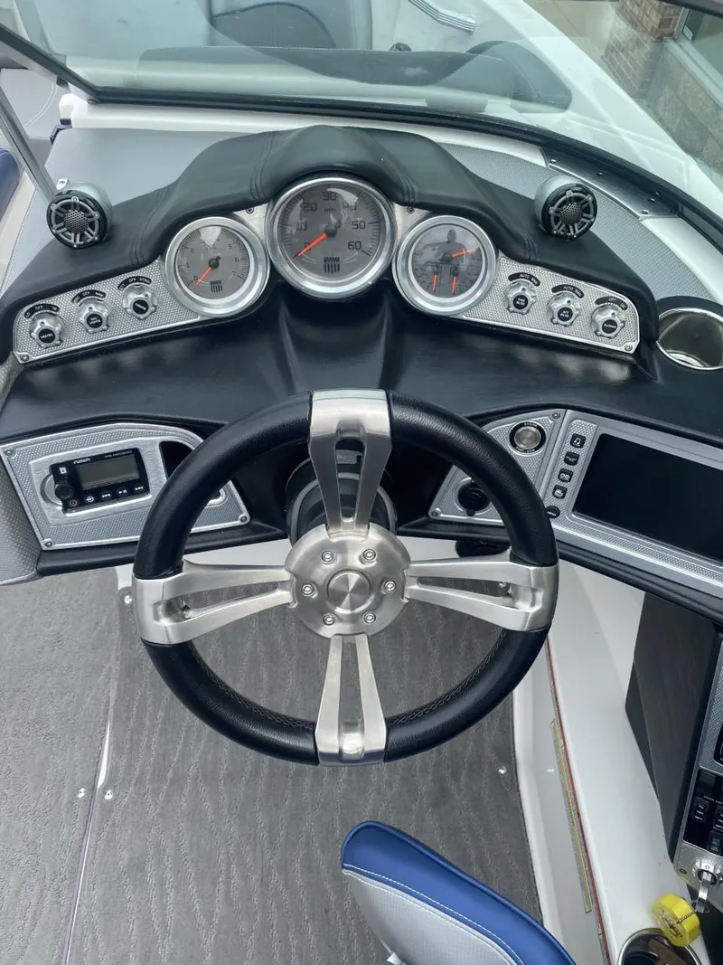 Slide: The Image of 2016 MasterCraft X23 dashboard with steering wheel and gauges. - 11