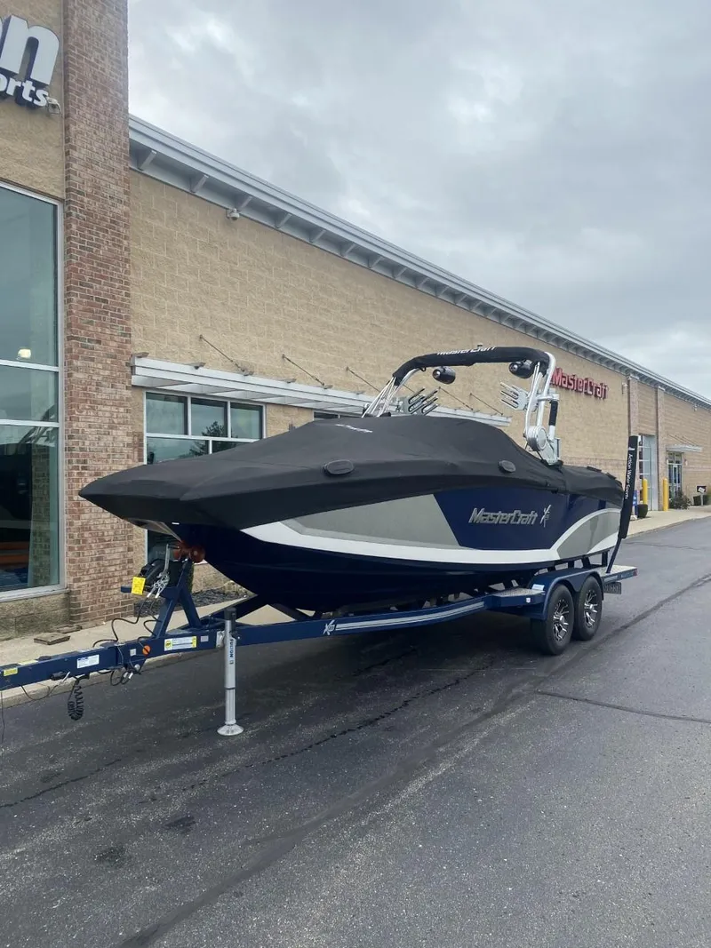 Slide: The Image of 2016 MasterCraft X23 boat on trailer outside dealership. - 6