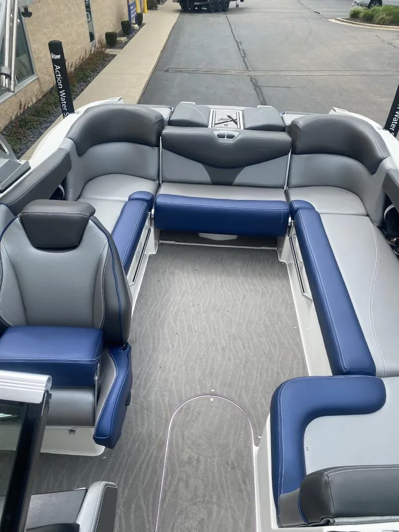 Slide: The Image of 2016 MasterCraft X23 boat interior with gray and blue seating. - 7
