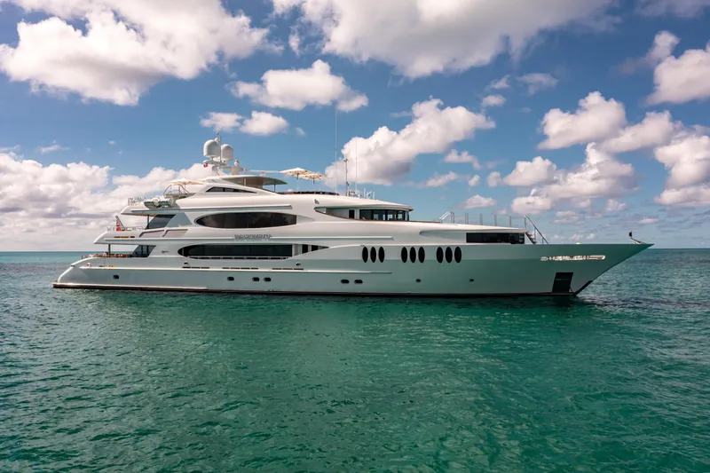 The Image of Luxurious 2011 Trinity Yachts CUSTOM yacht on clear blue water under a partly cloudy sky. - 0