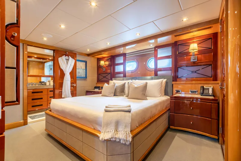 Slide: The Image of Luxurious bedroom on a 2011 Trinity Yachts CUSTOM yacht with elegant wood finishes. - 14