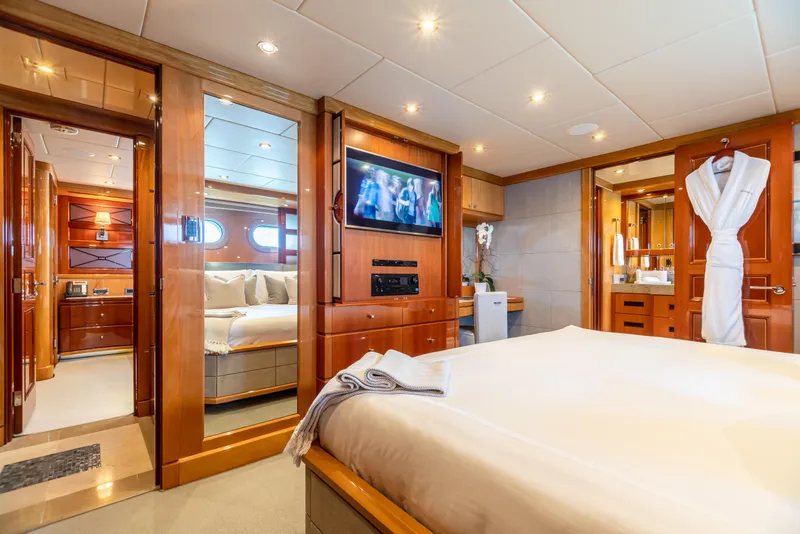 Slide: The Image of Luxurious bedroom on 2011 Trinity Yachts CUSTOM with TV, ensuite bathroom, and elegant wood finishes. - 15