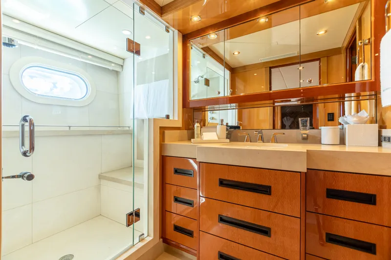 Slide: The Image of Luxurious bathroom on 2011 Trinity Yachts CUSTOM with glass shower and wooden cabinetry. - 16