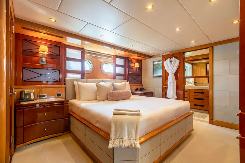 Slide: The Image of Luxurious bedroom on a 2011 Trinity Yachts CUSTOM yacht with elegant wood finishes. - 18