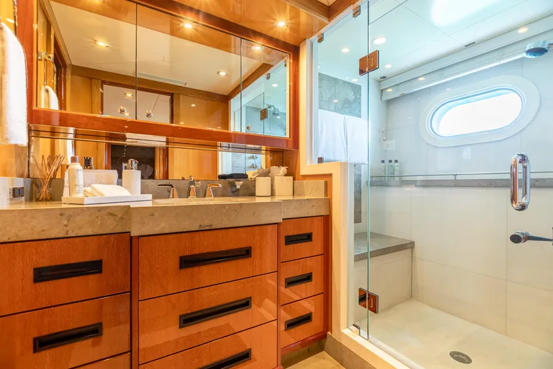 Slide: The Image of Luxurious bathroom on 2011 Trinity Yachts CUSTOM with wooden cabinetry and glass shower enclosure. - 22