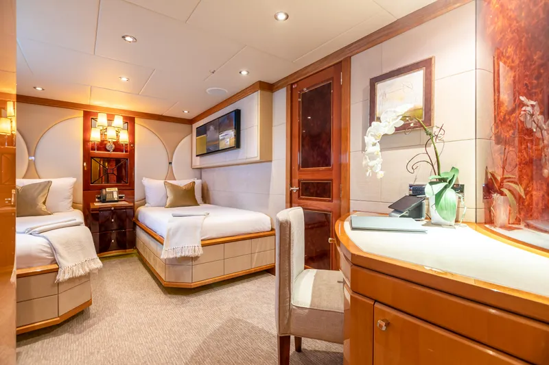 Slide: The Image of Luxurious bedroom on 2011 Trinity Yachts CUSTOM with twin beds, elegant decor, and ambient lighting. - 25