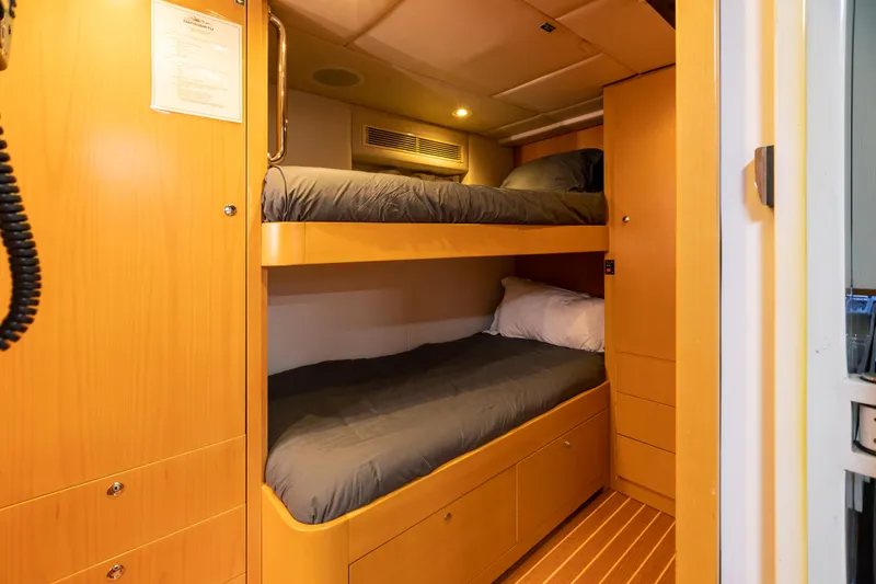 Slide: The Image of 2011 Trinity Yachts CUSTOM interior with bunk beds and wooden cabinetry. - 45