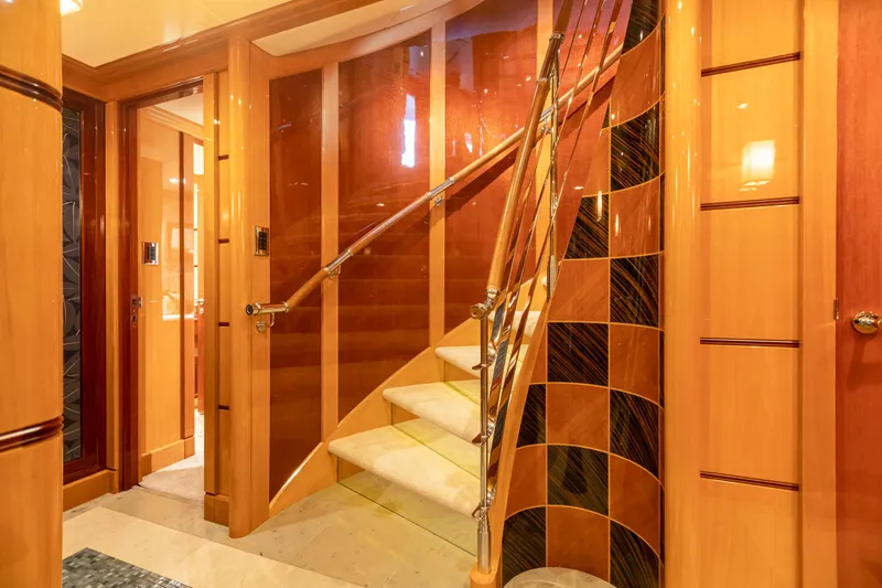 Slide: The Image of Luxurious interior staircase of 2011 Trinity Yachts CUSTOM model with elegant wood and metal finishes. - 5