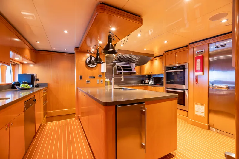 Slide: The Image of Luxurious kitchen on a 2011 Trinity Yachts CUSTOM yacht with modern appliances and wooden cabinetry. - 6
