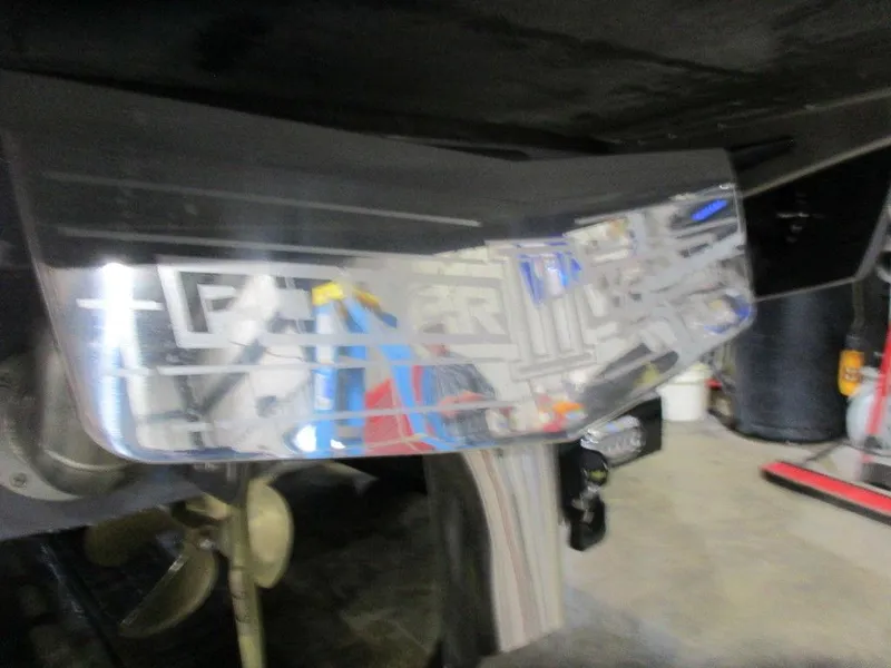 Slide: The Image of 2023 Axis T220 boat propeller and rudder in a garage. - 11