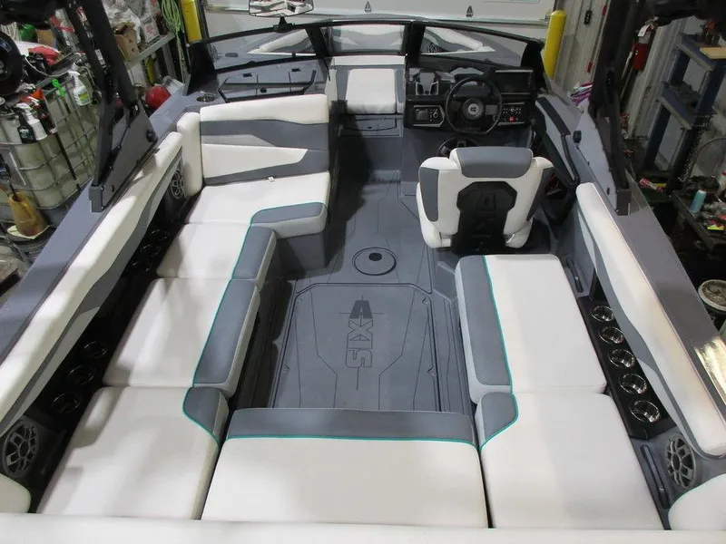 Slide: The Image of 2023 Axis T220 boat interior with white and gray seating, modern dashboard, and spacious layout. - 21