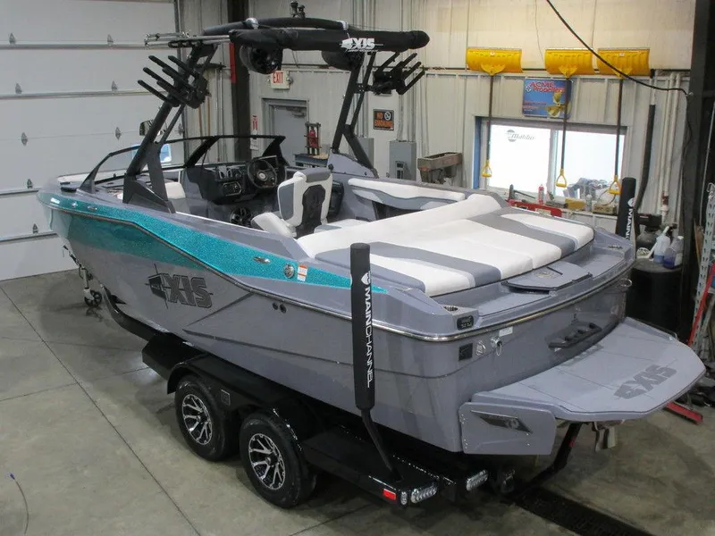 Slide: The Image of 2023 Axis T220 boat in a garage, featuring a sleek design and modern amenities. - 22