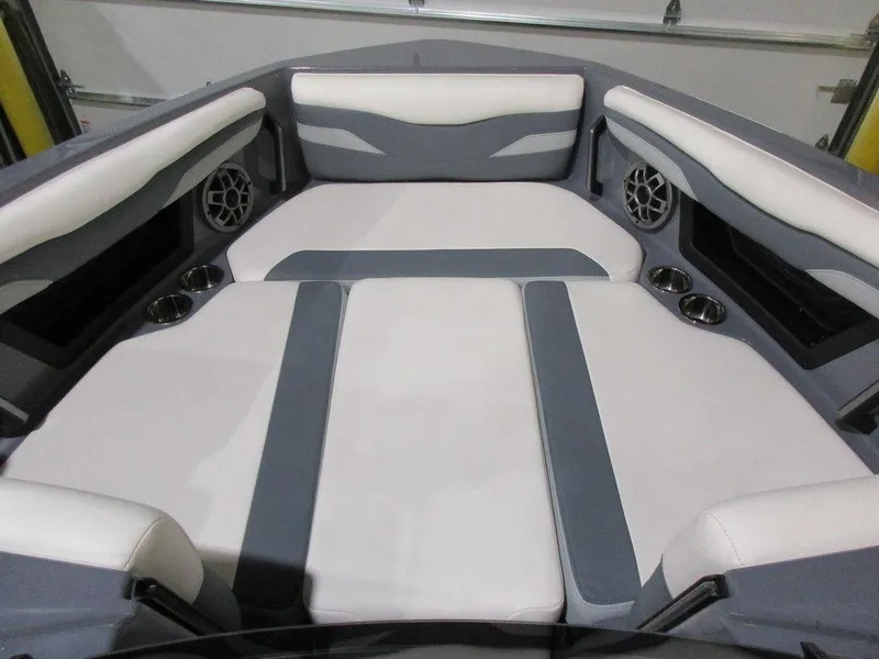 Slide: The Image of 2023 Axis T220 boat interior with cushioned seating and built-in speakers. - 23
