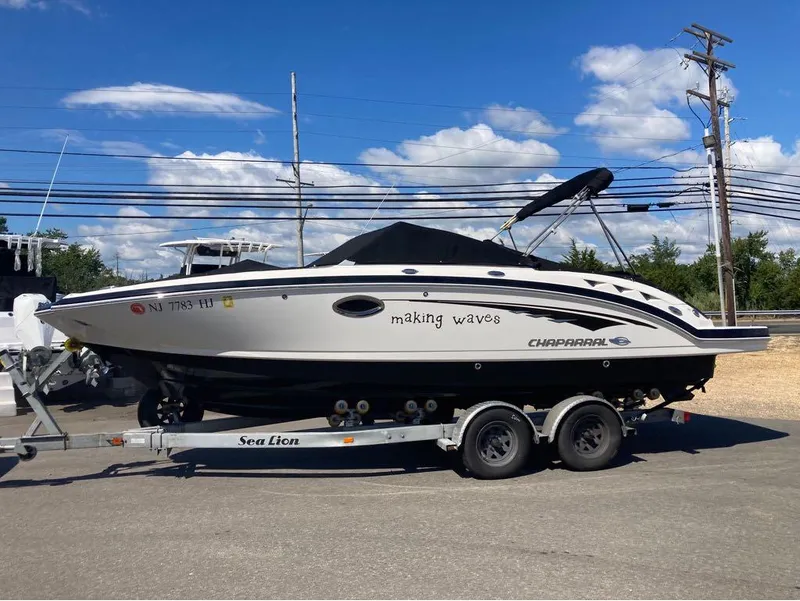 The Image of 2018 Chaparral 244 Sunesta boat on trailer under blue sky. - 1