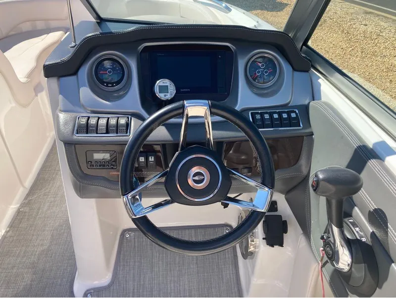 Slide: The Image of 2018 Chaparral 244 Sunesta boat dashboard with steering wheel and controls. - 3