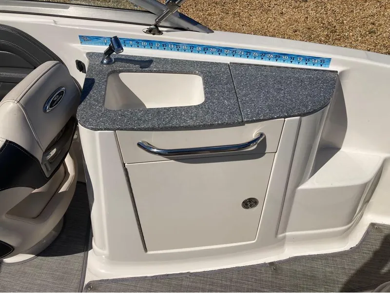 Slide: The Image of 2018 Chaparral 244 Sunesta boat interior with sink and storage cabinet. - 4
