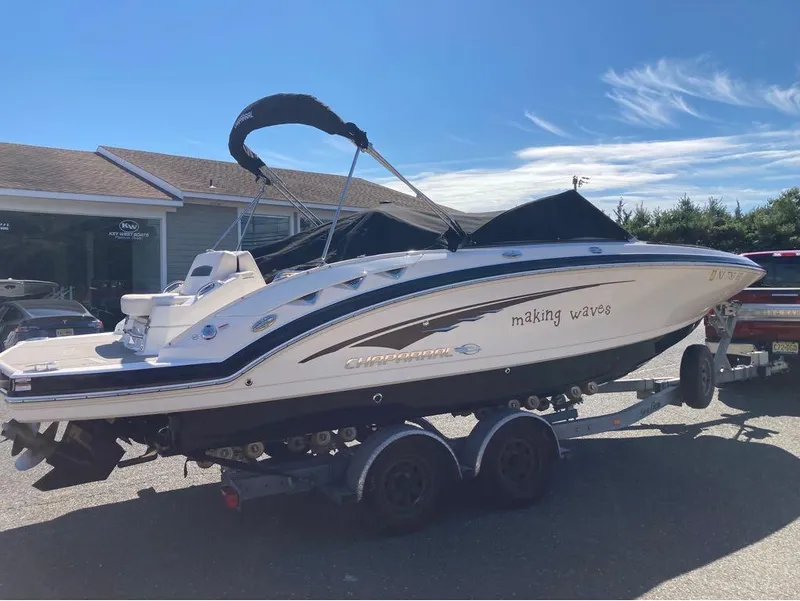 Slide: The Image of 2018 Chaparral 244 Sunesta boat on trailer, sunny day, "making waves" text on side. - 5