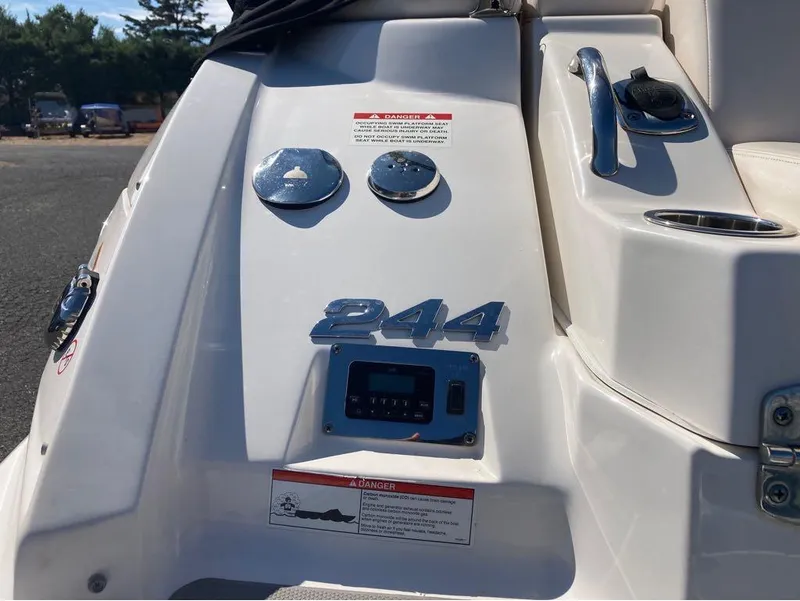 Slide: The Image of Close-up of 2018 Chaparral 244 Sunesta boat dashboard with controls and warning label. - 7