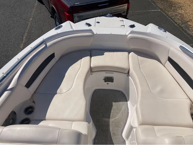 Slide: The Image of 2018 Chaparral 244 Sunesta boat interior with white seating and cup holders. - 8