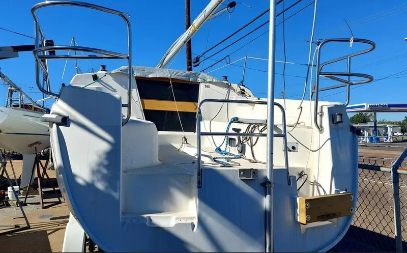 Slide: The Image of 1995 Hunter 26 sailboat stern view with railing and cockpit details. - 4