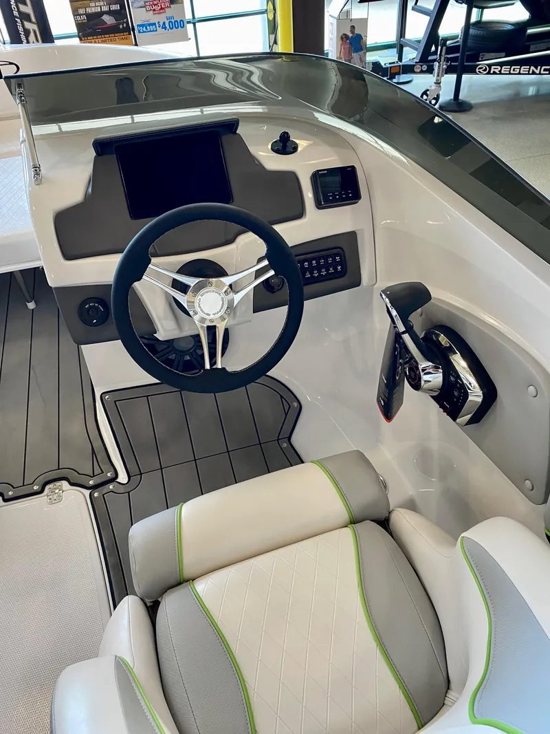 Slide: The Image of 2023 Tahoe 210 Si Limited boat cockpit with steering wheel and control panel. - 2