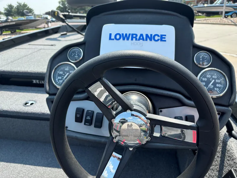 Slide: The Image of 2023 Ranger RT178 boat dashboard with Lowrance display and steering wheel. - 2